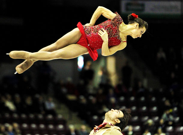 Meagan Duhamel tossed into the air by Eric Radford in the senior pairs short program at the Canadian National Figure Skating Championships. ?Photo by Reuters