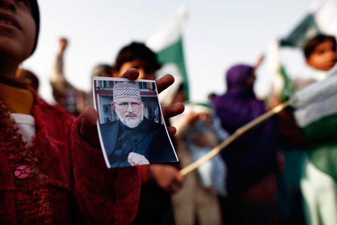 A girl holds a photograph of Muhammad Tahirul Qadri, leader of Mihaj-ul-Quran, during a protest in Islamabad January 14, 2013. ? Photo by Reuters