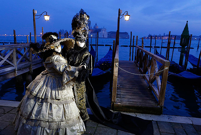 Marco Dilauro and his wife Nadia, wearing costumes, pose at San Marco square during the Venice Carnival. ? Reuters Photo