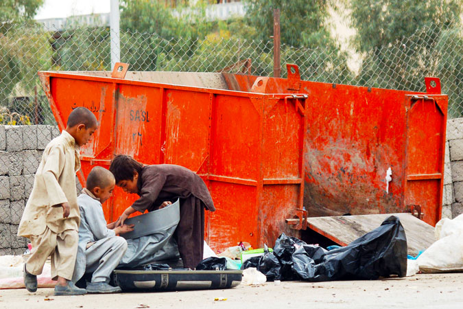 Afghan children search a garbage dump for useful items in Kandahar. ? Photo by AFP