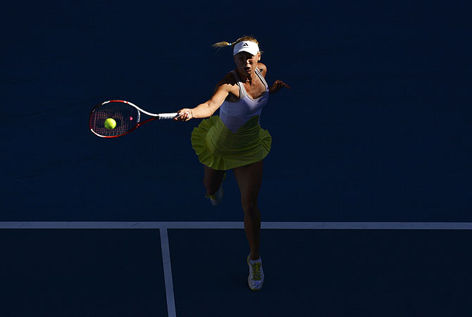 Caroline Wozniacki of Denmark hits a return to Lesia Tsurenko of Ukraine during their women's singles match. -Photo by Reuters