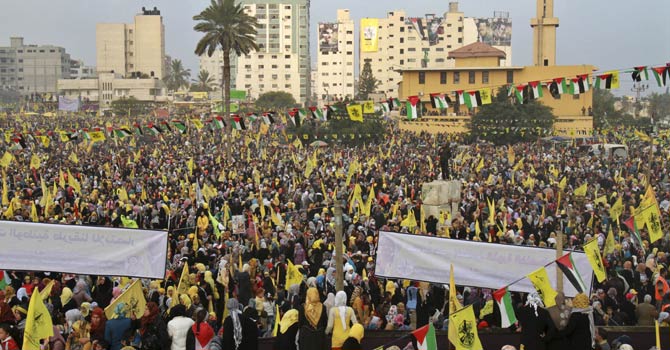 Palestinians hold yellow Fatah flags during celebrations marking the 48th anniversary of the Fatah movement in Gaza City, Friday, Jan. 4, 2013. Leaders of the Palestinian Fatah party led tens of thousands of supporters Friday in a mass rally in the Gaza Strip, the first such gathering for the largely secular party in the territory since the rival Islamist Hamas seized power there in 2007. - AP Photo