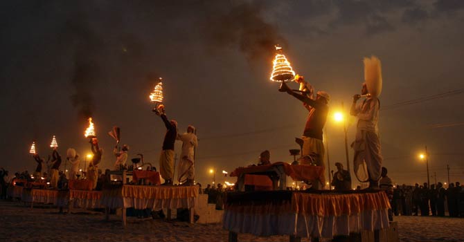Hindu priests hold oil lamps as they perform evening prayers on the banks of river Ganges during the “Kumbh Mela”, or Pitcher Festival, in the northern Indian city of Allahabad Jan 17, 2013. During the festival, hundreds of thousands of Hindus take part in a religious gathering at the banks of the river Ganges. “Kumbh Mela” will again return to Allahabad in 12 years. - Reuters
