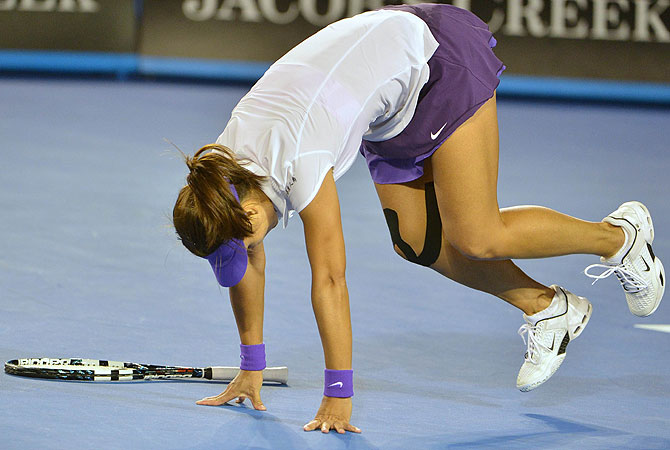 On the first point after a 10-minute pause in the third set while fireworks crackled overhead from nearby Australia Day celebrations, the Chinese player fell over again and slammed the back of her head into the court. -Photo by AFP