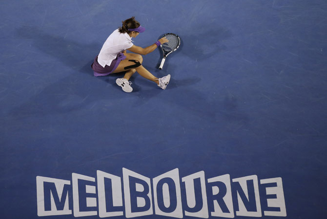 Li first tumbled to the court after twisting her left ankle, and had it taped after falling in the fifth game of the second set. -Photo by AP
