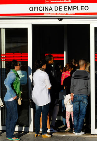 A file photo taken on September 4, 2012, shows people waiting in line at a government employment office in central Madrid, Spain. -Photo by AFP