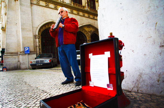 Jose Fonseca, 62, who has been unemployed for six months, plays music on the street for money in downtown Lisbon, Portugal. Fonseca, who has been working in the construction sector for 43 years, says he receives 274 euro ($358.5) as a monthly unemployment benefit. -Photo by AP