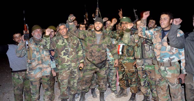Pro-government forces celebrate their alleged victory in a battle against rebels at the Air Defence Base in Tal Hassil 15 km from Aleppo Airport on Dec 30, 2012. International envoy Lakhdar Brahimi warned the Syrian war was worsening “by the day” as he announced a peace plan he believed could find support from world powers, including key Syria ally Russia. - AFP Photo