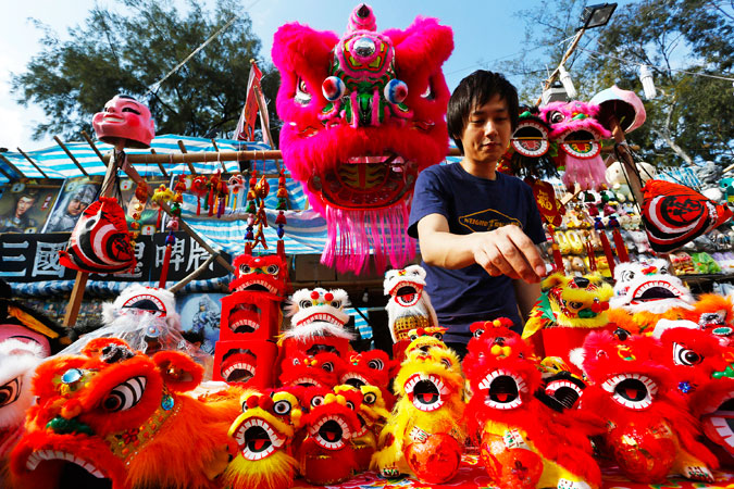A vendor sells Chinese New Year decorations at a market in Hong Kong's Victoria Park. ?Photo by AP