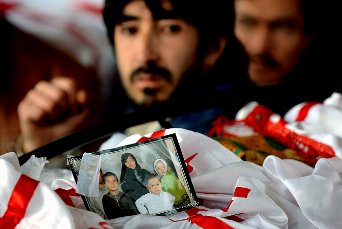 A family portrait is pictured on a coffin as Pakistani Shiite Muslims gather around the coffins of bomb attack victims on the second day of protests following the blast. ? AFP Photo