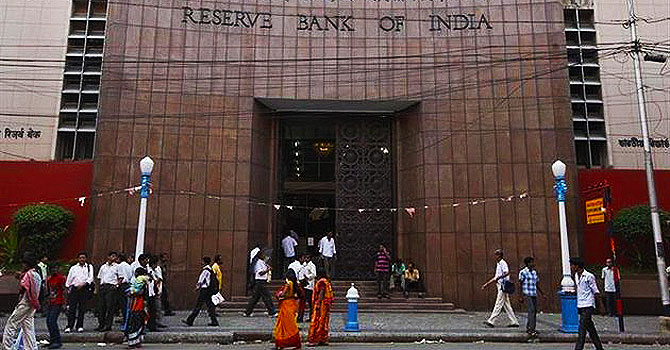 People walk in front of the Reserve Bank of India (RBI) building in Kolkata. —Photo (File) Reuters