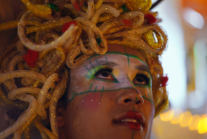 A dancer looks on during a Chinese New Year evening parade at Hong Kong's Tsim Sha Tsui shopping district.?Photo by Reuters