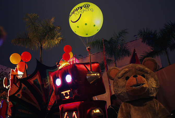 Dancers dressed as a robot and a teddy bear perform during a Chinese New Year evening parade at Hong Kong's Tsim Sha Tsui shopping district.?Photo by Reuters