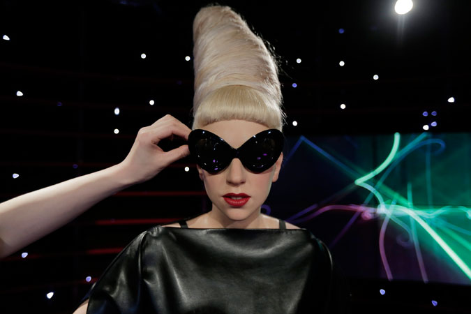 A figure production maintenance staff adjusts the wax figure of Lady Gaga. ?Photo by AP