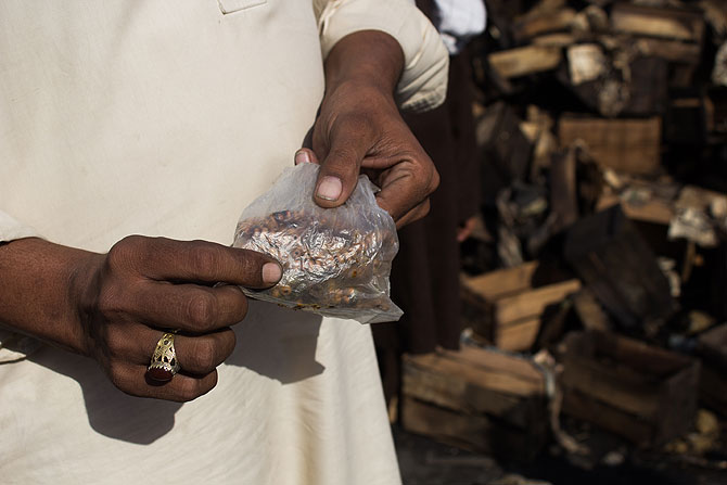 Shopkeeper Shahid Akbar could only retrieve his prayer beads from his shop, as everything else was burnt to ashes.