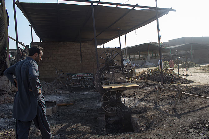 A man stands outside the area where his vegetable stall used to be. Many shopkeepers plan to hold protests if not compensated well.