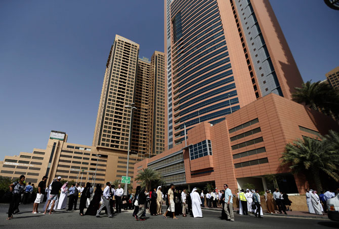 Employees gather outside their offices, located in high-rise buildings, in Dubai, following a powerful earthquake that hit southwest Iran and was felt in the United Arab Emirates. The earthquake, which the US Geological Survey measured at 7.8, killed at least five people and wounded others in a remote community and was felt across large parts of Pakistan as well.