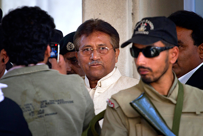 Pakistan's former president and military ruler Pervez Musharraf, center, leaves after appearing in court in Rawalpindi, Pakistan on Wednesday, April 17, 2013.