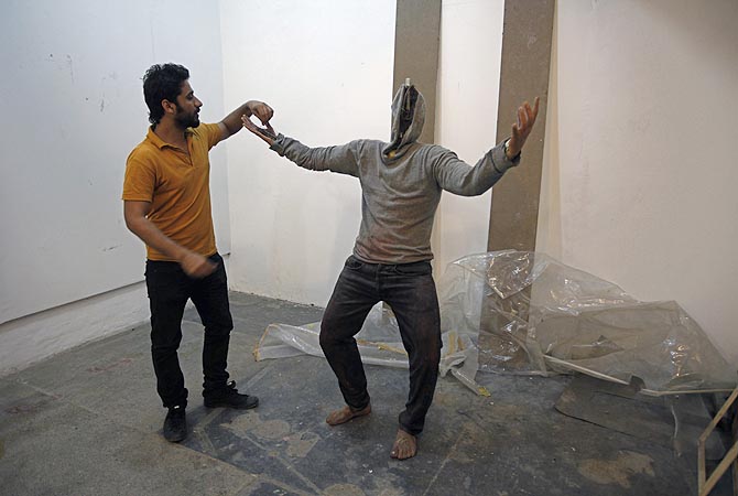 Saud Baloach, 28, a fine art artist, shows his incomplete statue "The Burden" during an interview with Reuters at Government College University in Lahore.
