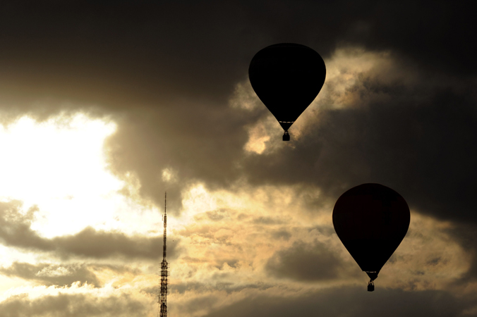 Hot air balloons fly near a TV tower during the National Ballooning Festival in Brasilia. The festival is part of the Brazilian capital´s 53rd anniversary celebrations. —Photo by AFP