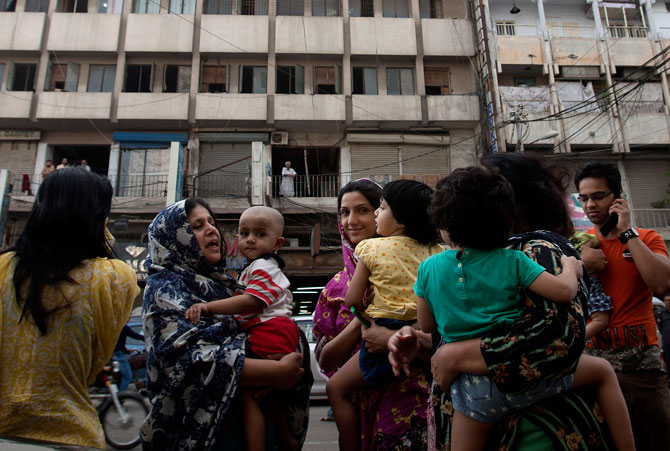 People evacuate buildings and gather on road as tremor of an earthquake was felt in Karachi.