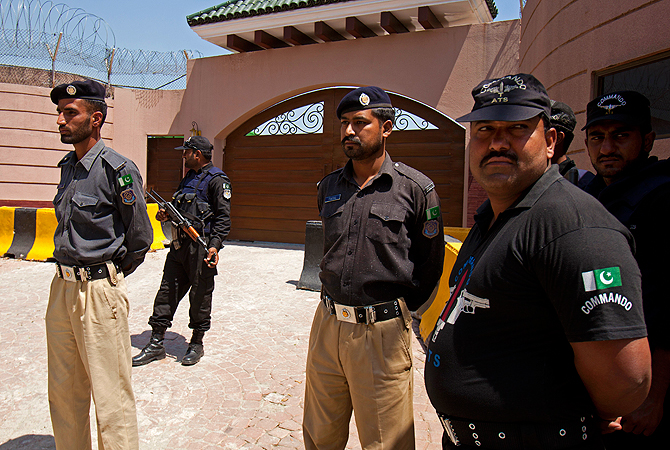 Pakistan police officers stand alert outside the house of Pakistan's former President and military ruler Pervez Musharraf in Islamabad, Pakistan, Thursday, April 18, 2013.