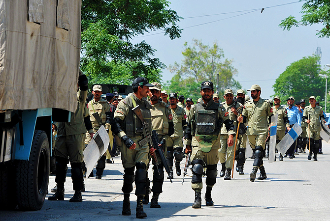 Pakistani paramilitary soldiers exit the high court building premises after the case hearing of former military ruler Pervez Musharraf in Islamabad.