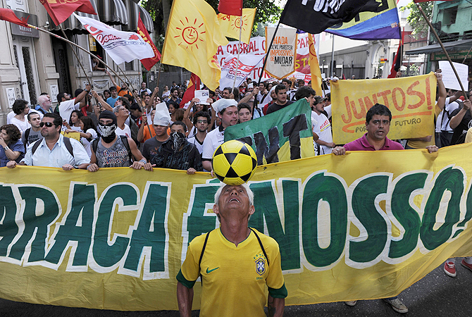 Activists protest in front of the Guanabara state government's palace against the privatization of the Mario Filho "Maracana" stadium in Rio de Janeiro, Brazil. Bidding for the privatization of Rio's iconic Maracana stadium was to go ahead as planned Thursday after a local court rejected an appeal to block the process. Maracana, which was built for the 1950 World Cup, is undergoing extensive renovation at a cost of 430 million dollars to host four Confederations Cup matches in June as well as seven World Cup games