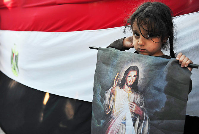 Egyptian Coptic Christians living in Greece protest against the recent deadly sectarian violence in Egypt in Athens. Egypt's Pope Tawadros II accused the day before President Mohamed Morsi of "negligence" in his response to deadly clashes outside Cairo's Coptic cathedral, the worst sectarian crisis since he took power last June.
