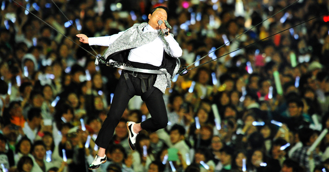 In a file picture taken on April 13, 2013, Psy performs during his concert “Happening” in Seoul. Psy's new music video crossed the 100 million views mark on YouTube, shattering another record on the video-sharing site since its much-anticipated weekend debut. —AFP Photo