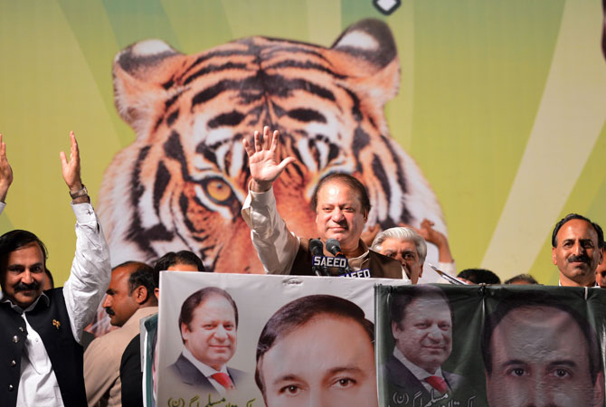 Former Pakistani Prime Minister Nawaz Sharif (C) waves as he addresses his supporters during an election campaign meeting in Islamabad on May 5, 2013.