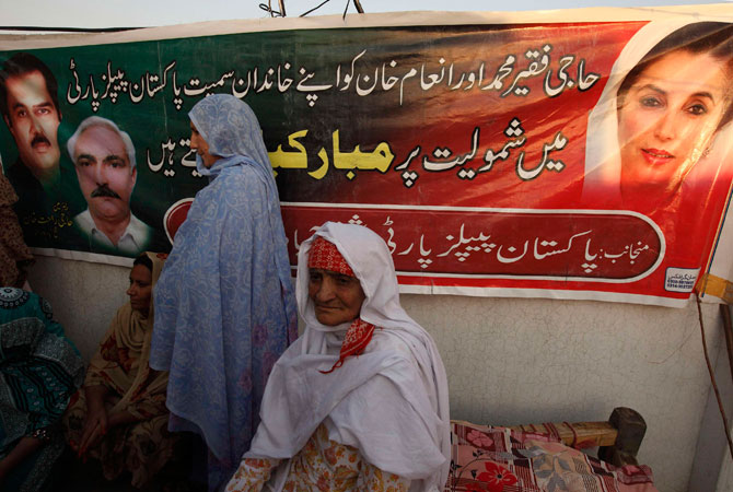 Women attend a clandestine campaign rally by PPP female candidates for the upcoming election, on a roof of a building.