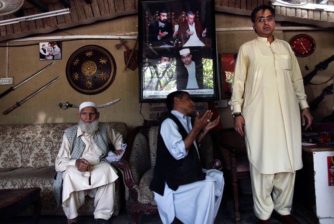 Haroon Bilour (R), an Awami National Party (ANP) candidate for the upcoming elections, meets constituents seeking help for problems at his house in Peshawar.