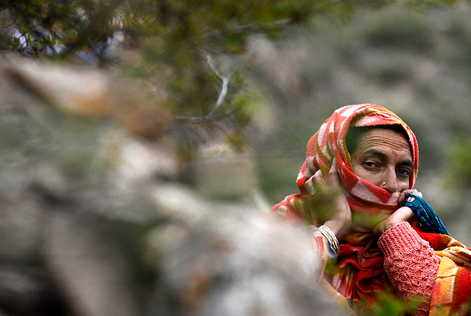 A Kashmiri muslim woman prays during the annual Aishmuqaam festival at the shrine of Sufi saint Zain-ud-din Wali in Aishmuqaam, some 75 kms (47 miles) south of Srinagar, on April 24, 2013. The farming community in Kashmir celebrates the 'festival of lights', carrying torches and offering prayers, marking the end of winter and the beginning of the agricultural season. — AFP Photo