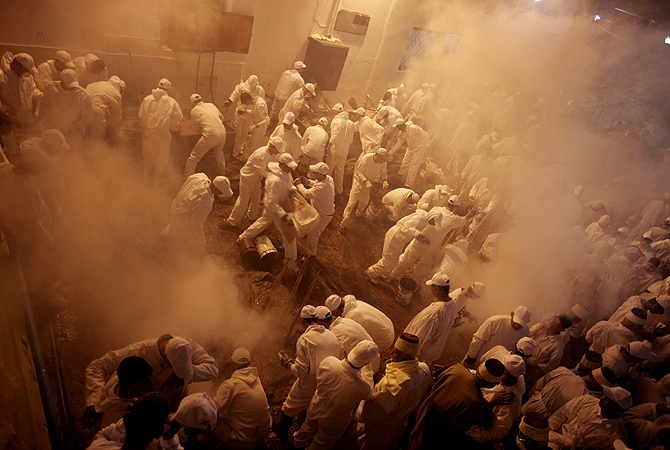 Samaritans take part in the traditional Passover sacrifice ceremony, where sheep and goats are slaughtered, at Mount Gerizim near the northern West Bank city of Nablus on April 23, 2013. The Israeli Samaritan community which numbers about 720 people practice a religion that is based on four principles of faith, one God - the God of Israel; one Prophet - Moses Ben Amram; the belief in the Torah - the first five books of the Bible and one holy place - Mount Gerizim, close to Tel Aviv in Israel. — AFP Photo