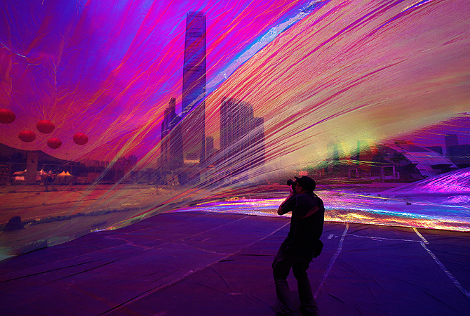 A photographer takes picture from inside an art piece "Poetic Cosmos of the Breath" by Argentina-born artist Tomas Saraceno as part of an exhibition "Inflation!" at the site of an upcoming park in the West Kowloon cultural district in Hong Kong April 24, 2013. "The Park" as it will be called, will cover 14 hectares of landscaped public space devoted to the arts and culture and will open by phases starting from 2014/15, according to the official press release. — Reuters Photo