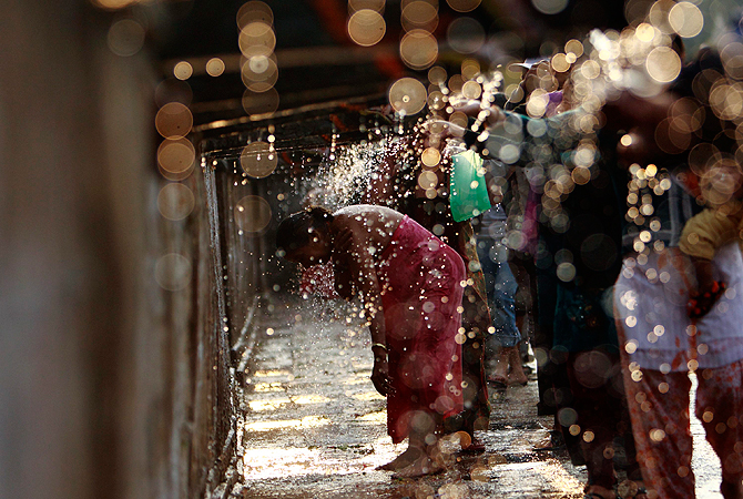 A devotee takes a holy bath at the Balaju Baise Dhara (22 water spouts) during the Baishak Asnan festival in Kathmandu April 25, 2013. Devotees believe that the water from these stone spouts, which is collected from the catchment area of the Nagarjun forest behind the spouts, will cure pains and skin diseases. — Reuters Photo