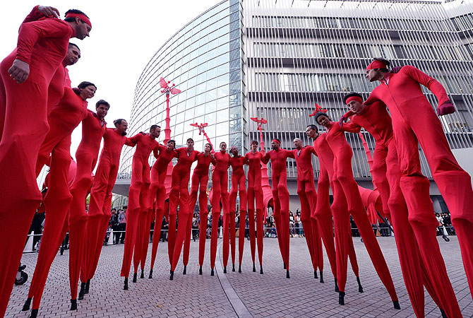 French performance group Compagnie Off members gather before performing 'Les Girafes', a stilt-walking show, at Roppongi Hills in Tokyo on April 29, 2013. The performance was held to celebrate the 10th anniversary of the Roppongi Hills, a large-complex that incorporates offices, shopping malls, theaters, a museum and a luxury hotel. — AFP Photo