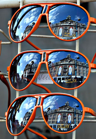 Orange sunglasses on sale in a shop in central Amsterdam on April 29, 2013 on the eve of the investiture of the country's new King. Dutch Queen Beatrix, who ruled the Netherlands for 33 years, announced on January 28, 2013 her abdication from the throne in favour of her son, Prince Willem-Alexander. — AFP Photo