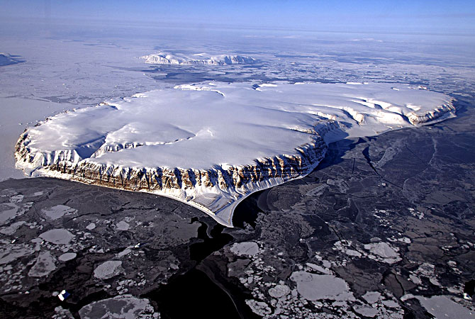 Nasa handout image shows Saunders Island and Wolstenholme Fjord with Kap Atholl in the background seen during an IceBridge survey flight near Qaasuitsup, Greenland. Sea ice coverage in the fjord ranges from thicker, white ice seen in the background, to thinner grease ice and leads showing open ocean water in the foreground. — AFP Photo