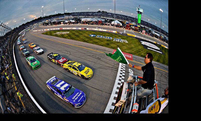 In this photo made using a fisheye lens, Matt Kenseth (20) and Brian Vickers (11) lead the field at the start the Toyota Owners 400 NASCAR Sprint Cup Series race April 27, 2013, at Richmond International Raceway in Richmond, Va. — AP Photo