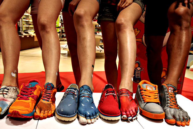 Feet painted like shoes are displayed during the opening ceremony of South Korean shoe store LesMore in Seoul, South Korea, Tuesday, April 30, 2013. — AP Phot
