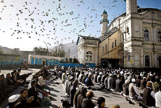 In this Friday, Oct. 26, 2012 file photo, Afghans listen to preacher while offering the Eid al Adha's prayers outside of Shah-e-Dushamshera mosque in Kabul, Afghanistan. As the country braces for next year's presidential election and the planned withdrawal of most foreign combat troops by the end of 2014, the panel urges the U.S. government and its allies to work harder to promote religious rights in the war-torn nation. — AP Photo