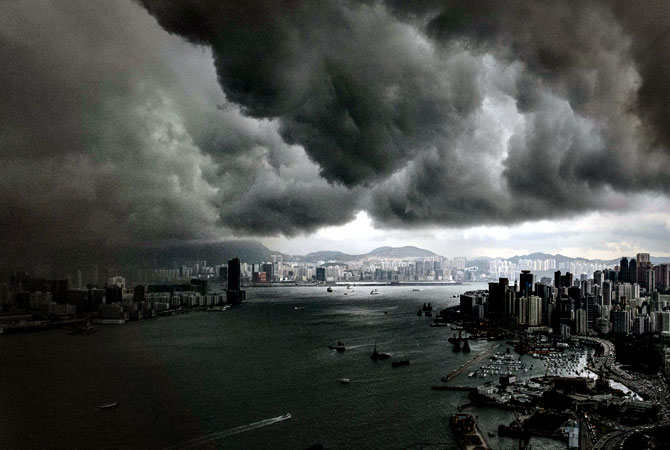 Clouds build up over the Victoria harbour before a storm in Hong Kong on April 30, 2013. — AFP Photo