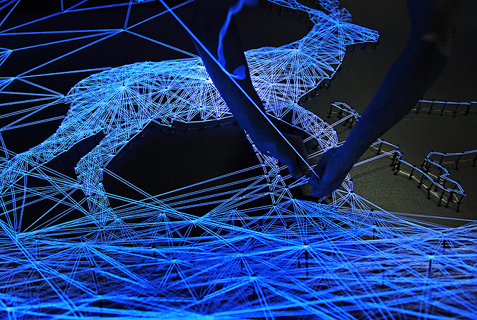 Artists install an installation art piece seen under Ultra-violet lighting titled "Stellar Cave II" by French artist Julien Salaud on Monday, May 13, 2013 in Singapore which will host the Art Garden 2013 art festival for about 3-months at the Singapore Art Museum. — AP Photo
