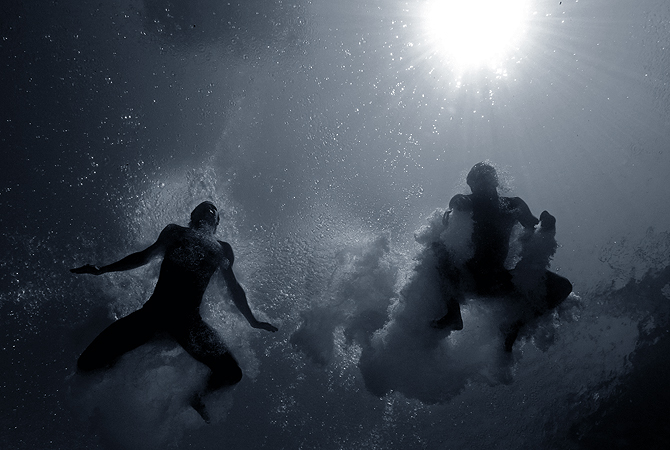 This digital image was converted to Black and White) Oleksandr Gorshkovozov and Dmytro Mezhenskyi of the Ukraine dive during the Men's 10 Meter Platform Synchronized Finals at the Fort Lauderdale Aquatic Center on Day 4 of the AT&T USA Diving Grand Prix on May 12, 2013 in Fort Lauderdale, Florida. — AFP Photo