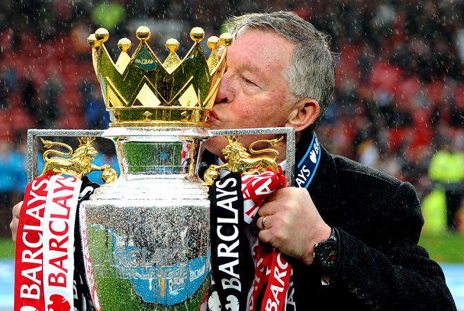 Manchester United's Scottish manager Alex Ferguson kisses the Premier League trophy at the end of the English Premier League football match between Manchester United and Swansea City at Old Trafford in Manchester, northwest England, on May 12, 2013. Ferguson said farewell to Old Trafford with a typically passionate speech after his side's 2-1 victory over Swansea in his final home match in charge of the team. — AFP Photo