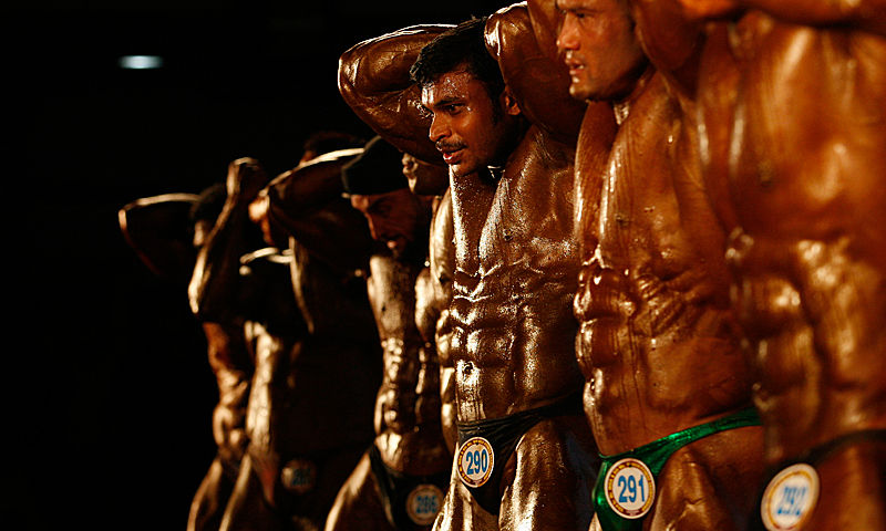 In this Wednesday, May 8, 2013 photo, Indian body builders display their muscles during Mr. India, an all India body building championship in Chennai, India. — AP Photo