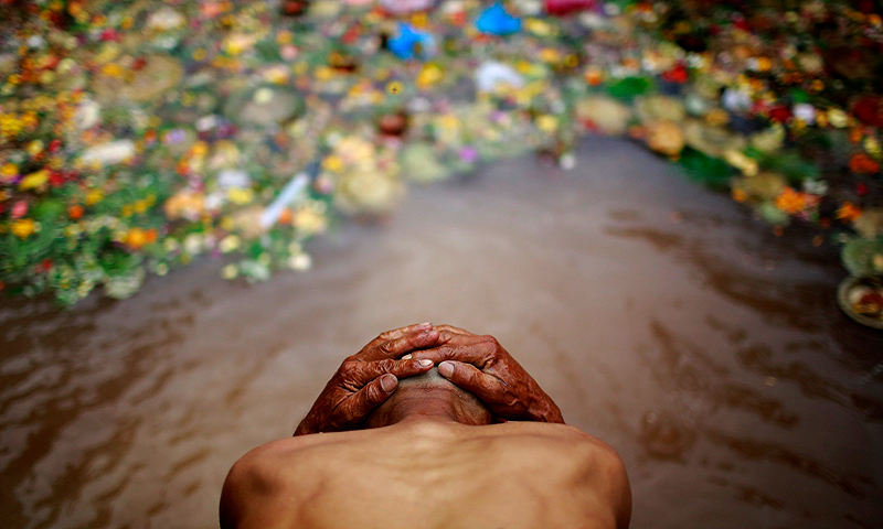 A man takes a holy bath at Matathirtha to observe Mother's Day in Kathmandu May 9, 2013. Families whose mothers have passed away take a holy wash and offer prayer at Matathirtha to commemorate the departed. — Reuters Photo