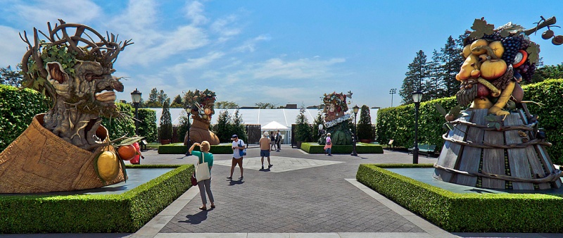 Visitors look at four 15-foot-high fiberglass busts of human heads by artist Philip Haas that are on display in the courtyard of the Enid A. Haupt Conservatory of the New York Botanical Garden in The Bronx, New York, May 16, 2013. Haas was inspired by the "Four Seasons" portraits of 16th century Italian Renaissance painter Giuseppe Arcimboldo to make the sculptures (L to R) that represent Winter, Summer, Spring and Autumn. Their features are made of faux vegetation including nuts, grapes, fruit, flowers, bark, and